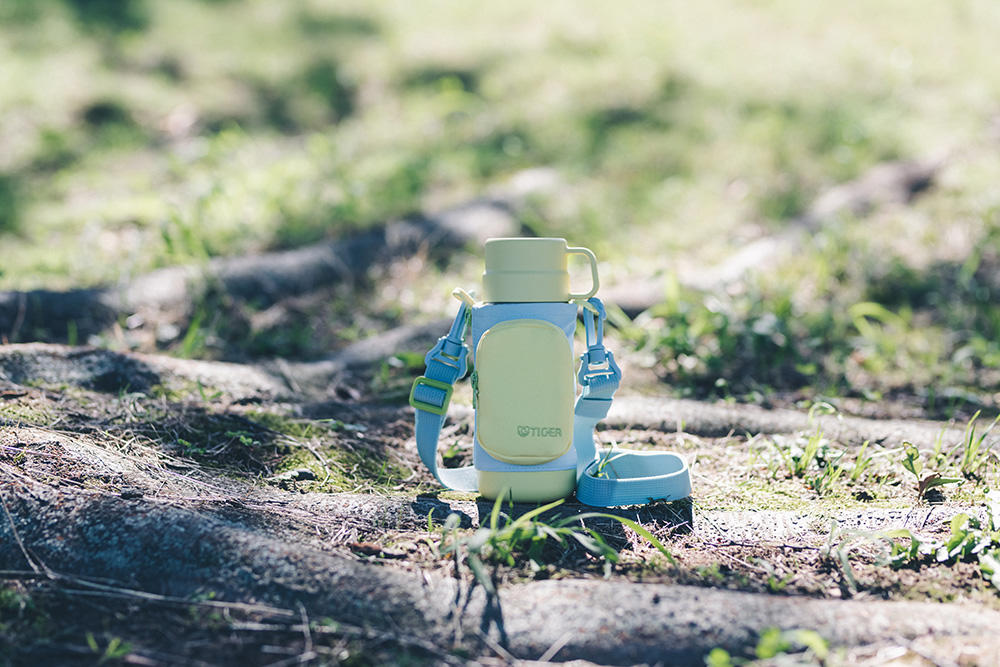A kids' bottle resting on the ground.