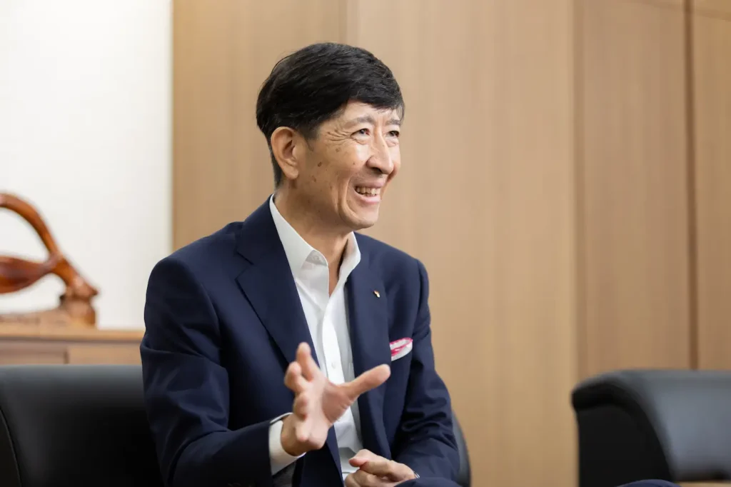 President Kikuchi discussing "joyous harmony" around the world.