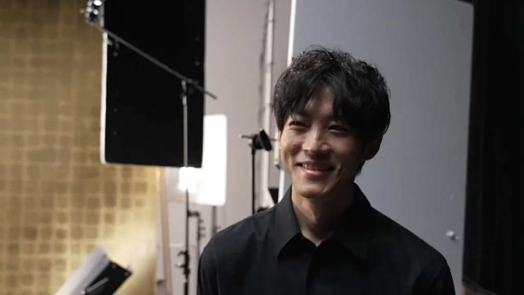 Tori Matsuzaka smiles between takes.
