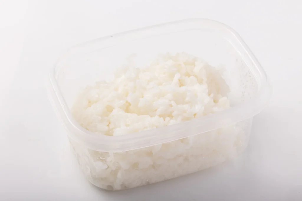 Cooked rice stored in a plastic food container